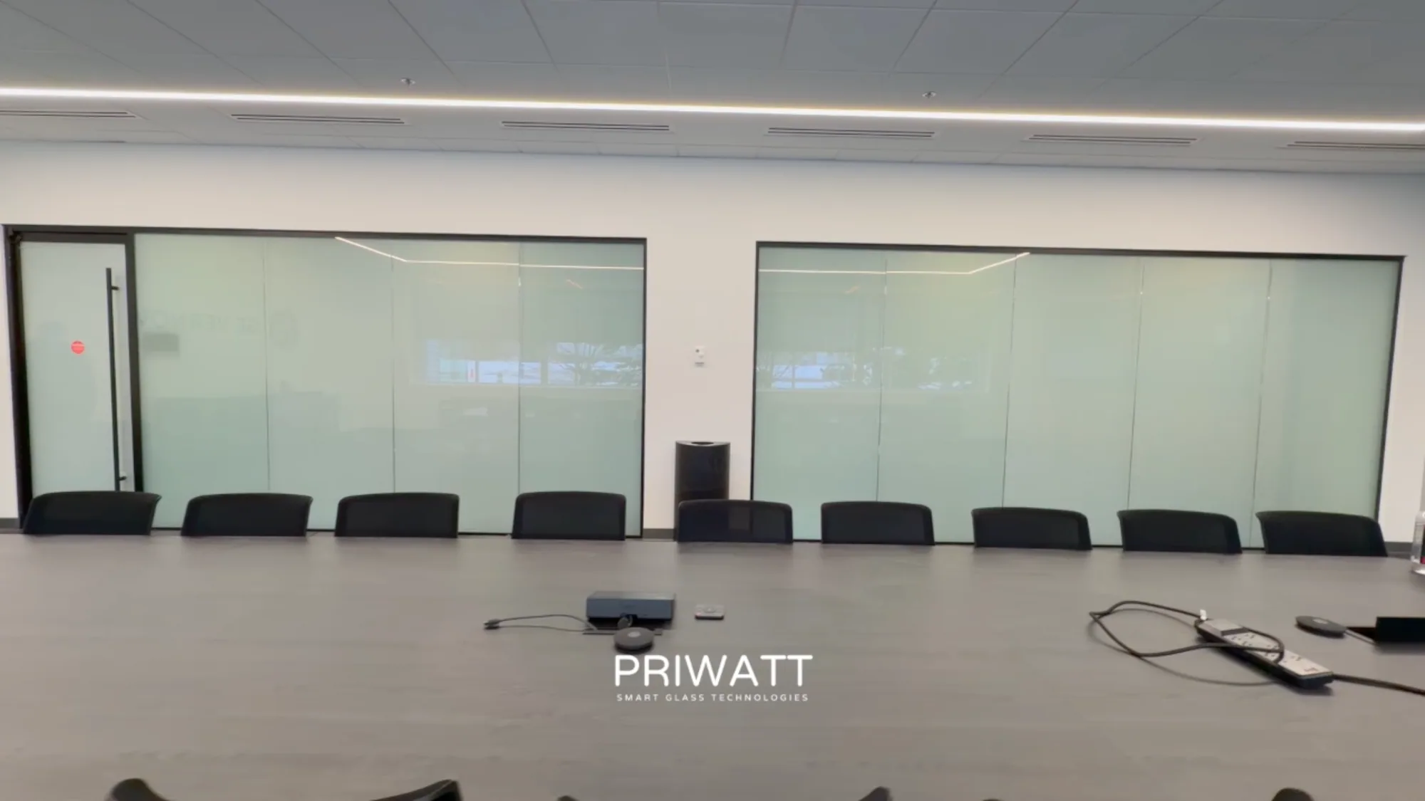 The same boardroom wall switched to privacy