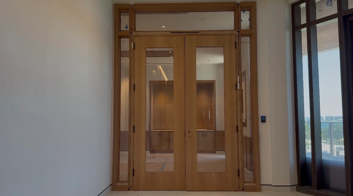 Interior double doors in reverse glass, clear, with the room and its cabinetry showing through