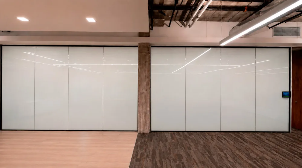 The same partition switched to privacy, the glass an even white and the room behind it no longer visible