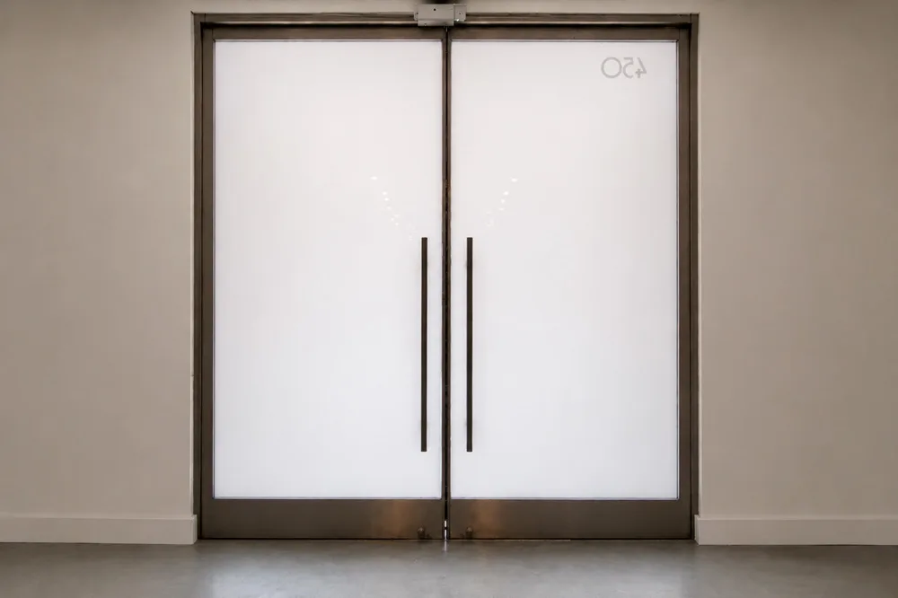 Retail entrance doors with PriWatt smart glass in privacy mode