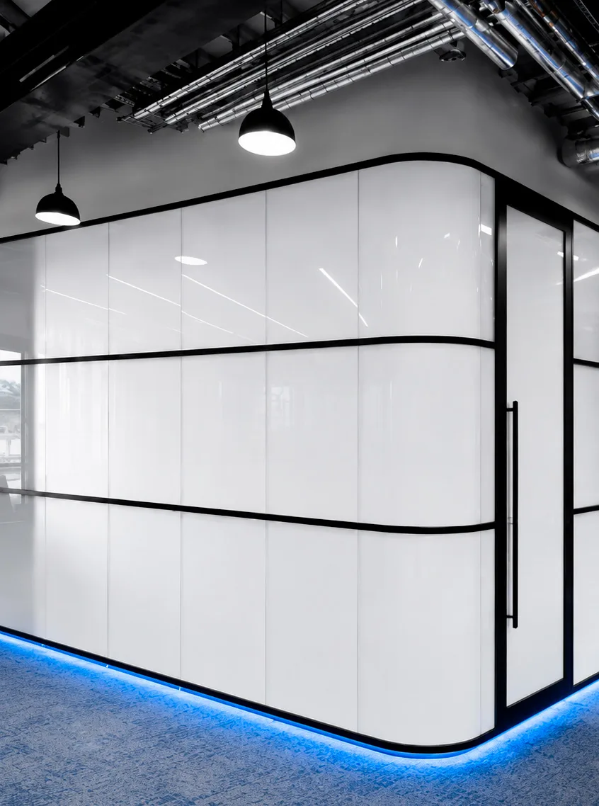 A curved PriWatt reverse switchable glass wall in a finished interior