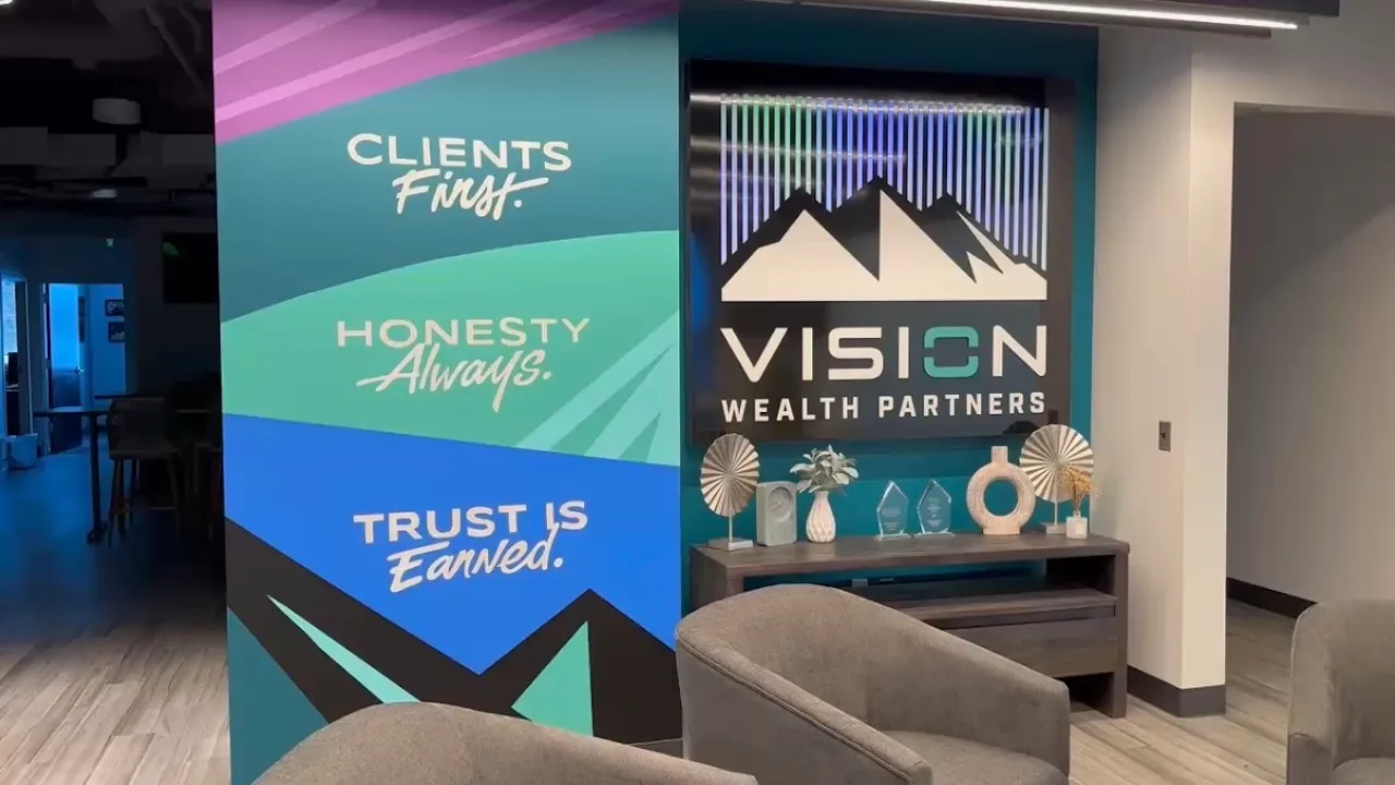 Vision Wealth Partners office with branded graphics on PriWatt smart glass