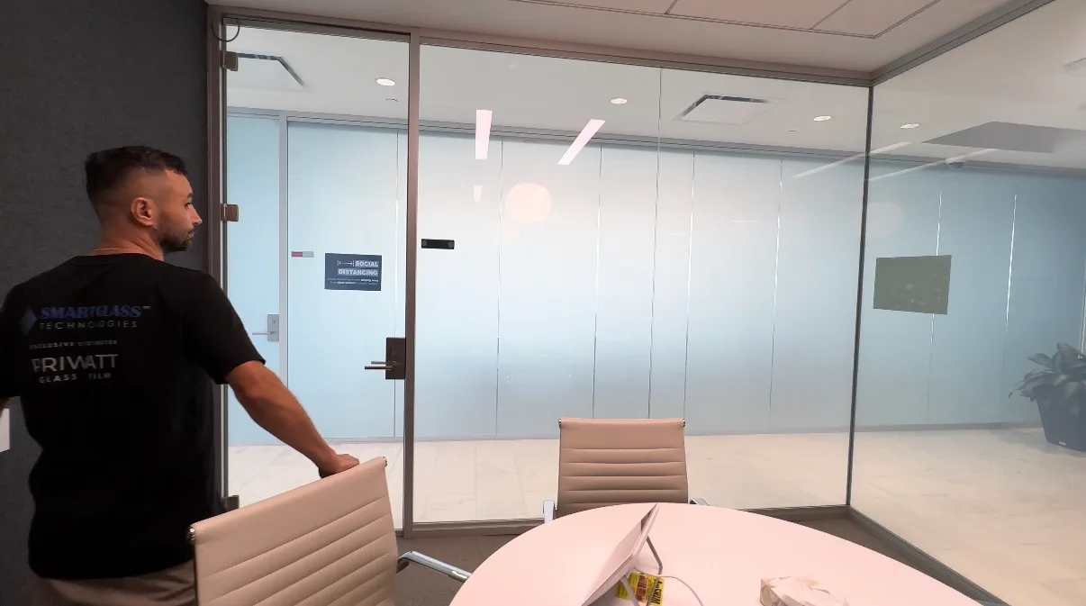PriWatt installer fitting a smart glass panel in an office