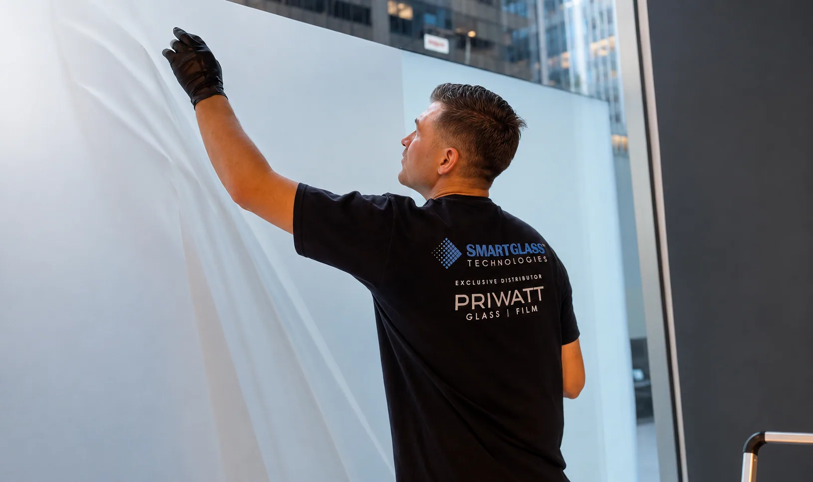 PriWatt technician handling a sheet of switchable smart film