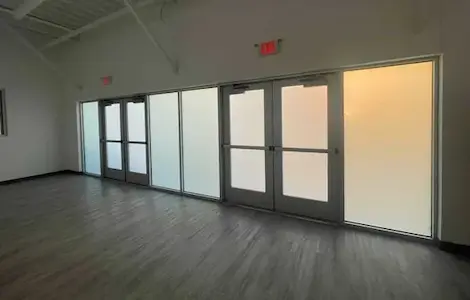 A frosted switchable partition closing off an empty suite