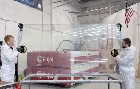 Operators at the Pujol laminating line in cleanroom suits