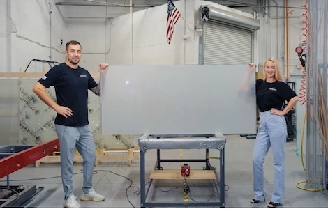 Two PriWatt staff presenting a finished switchable panel