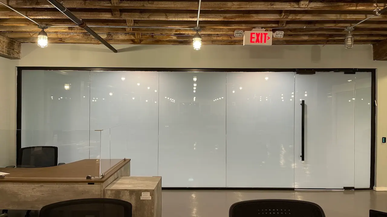 A glazed meeting room in GoPuff’s open-plan office, clear
